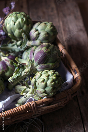 Green artichokes laid in basket photo