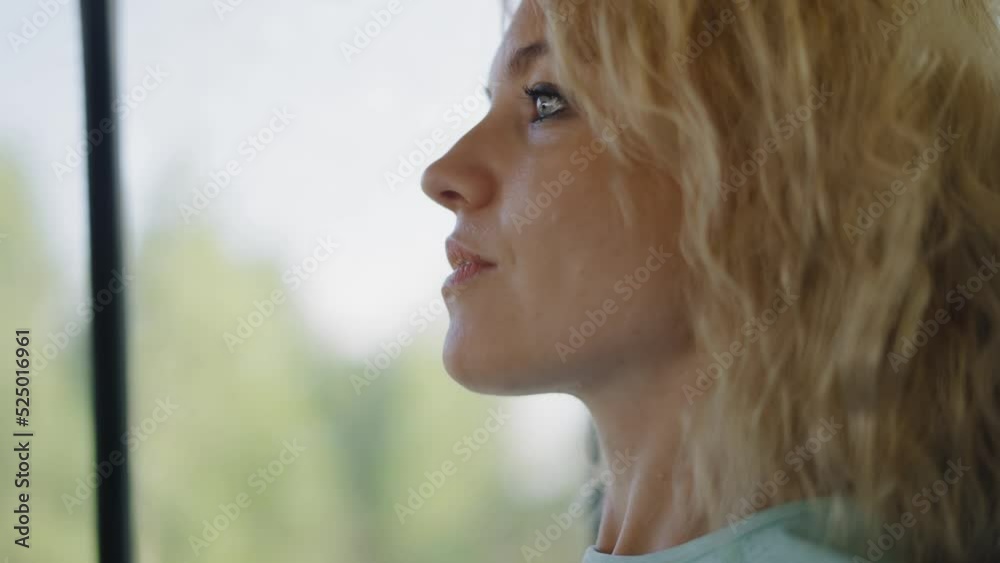 Gorgeous blonde woman rides in the back seat in a moving car. Gorgeous blonde woman rides in the back seat in a moving car.