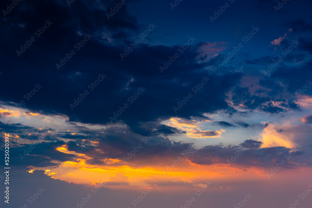 Fiery orange sunset sky. Beautiful sky. Beautiful orange clouds on a blue  sunset sky. Stock Photo