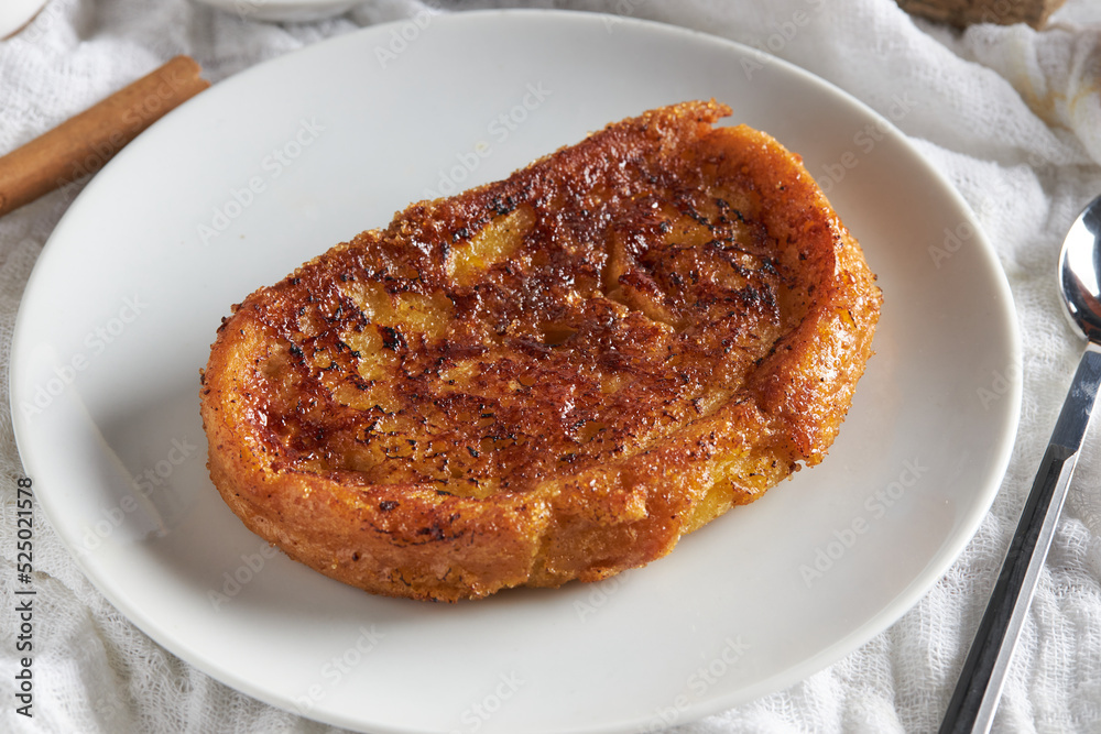 Plate of delicious torrija served on table with cutlery Plate of delicious torrija served on table with cutlery
