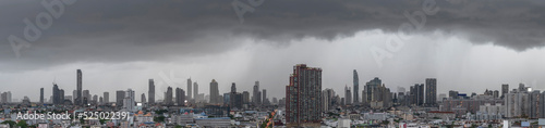 Modern city under dramatic stormy rainy clouds.