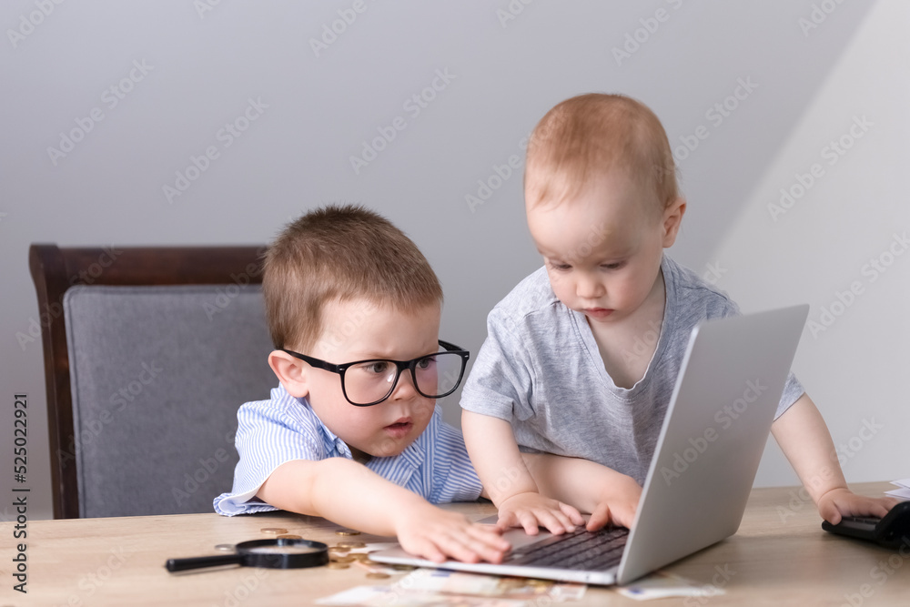 The younger brother prevents the elder from studying on a laptop. The younger brother prevents the elder from studying on a laptop.