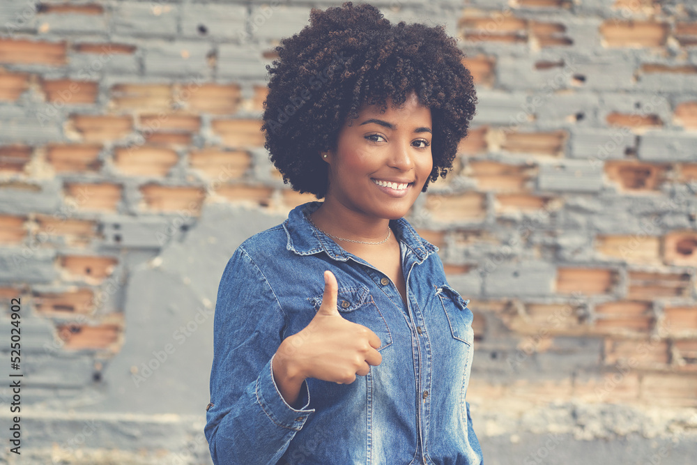 African american young adult woman showing thumb up African american young adult woman showing thumb up
