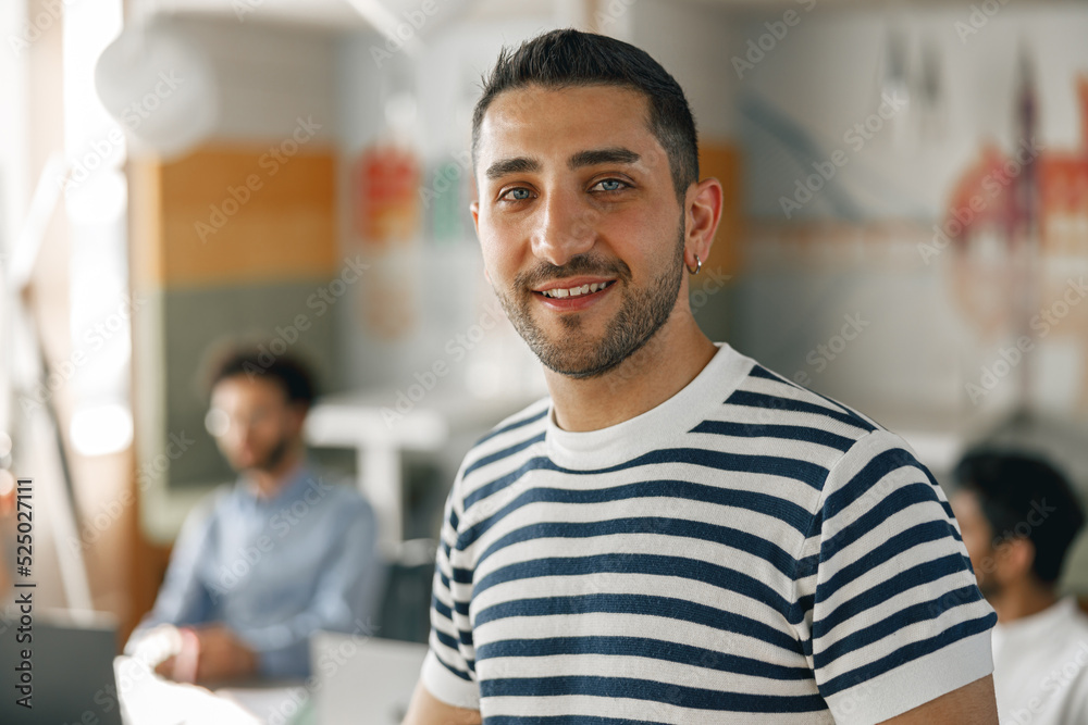 Portrait of smiling businessman in casual clothes standing in modern office Portrait of smiling businessman in casual clothes standing in modern office