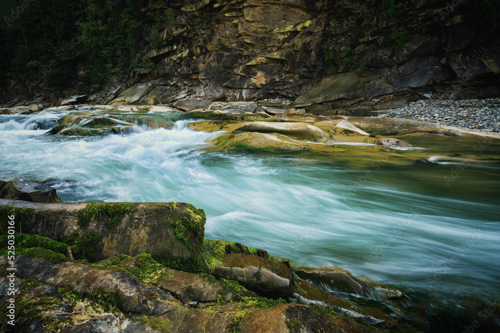 Mountain river among large stones on long exposure. artistic processing Mountain river among large stones on long exposure. artistic processing