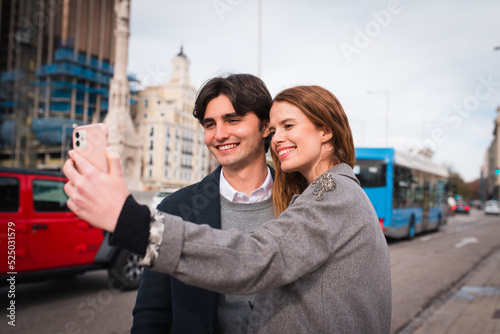 Loving young couple taking selfie on street