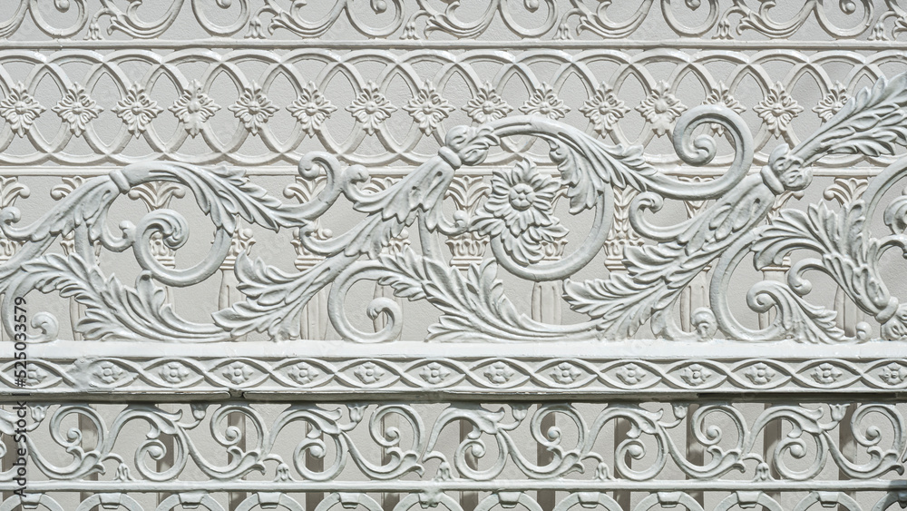 Abstract ornamental and decorative pattern background of vintage white cast iron sliding fence gate in Roman style