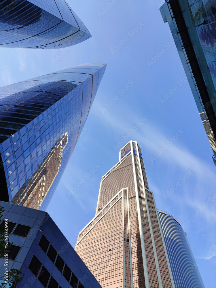 Bottom view on skyscrapers and blue sky in Moscow City, Russia. Modern office buildings in the financial district. Abstract background. High quality photo.