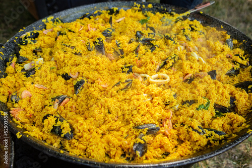 Paella traditional Spanish food. paella prepared on a large pan on the street on fire