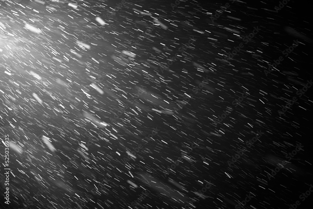 Snowflakes falling down on black background, heavy snow flakes isolated, Flying rain, overlay effect for composition, Motion blur effect