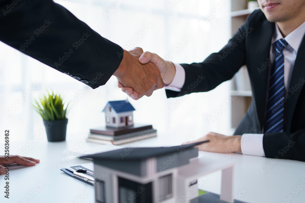 Agent and customer shake hands when successful trading houses. House and real estate trading ideas. Agent and customer shake hands when successful trading houses. House and real estate trading ideas.