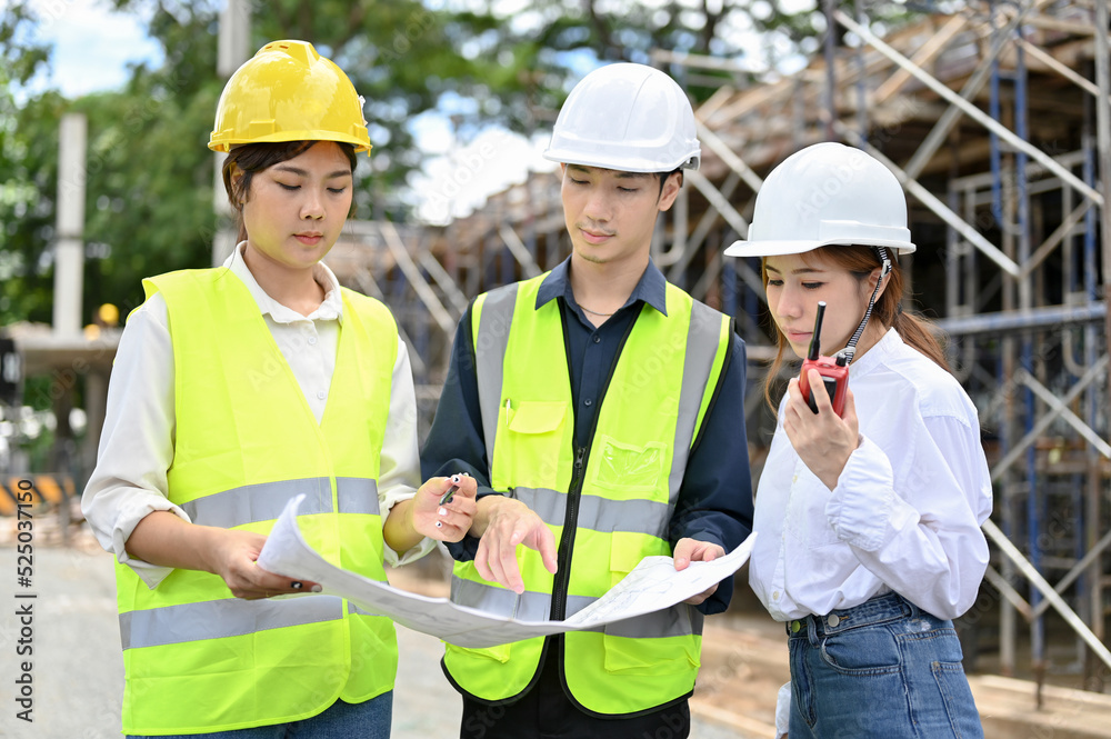 Female and male architects inspecting the building at the construction site. Female and male architects inspecting the building at the construction site.