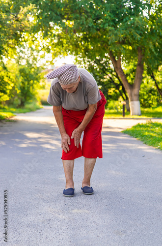 grandmother hurts her knee on the road. Selective focus. © yanadjan