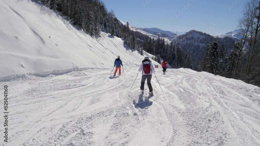 Skiers And Snowboarders Skiing Down Snowy Ski Slope Track In Mountains In Winter Skiers And Snowboarders Skiing Down Snowy Ski Slope Track In Mountains In Winter