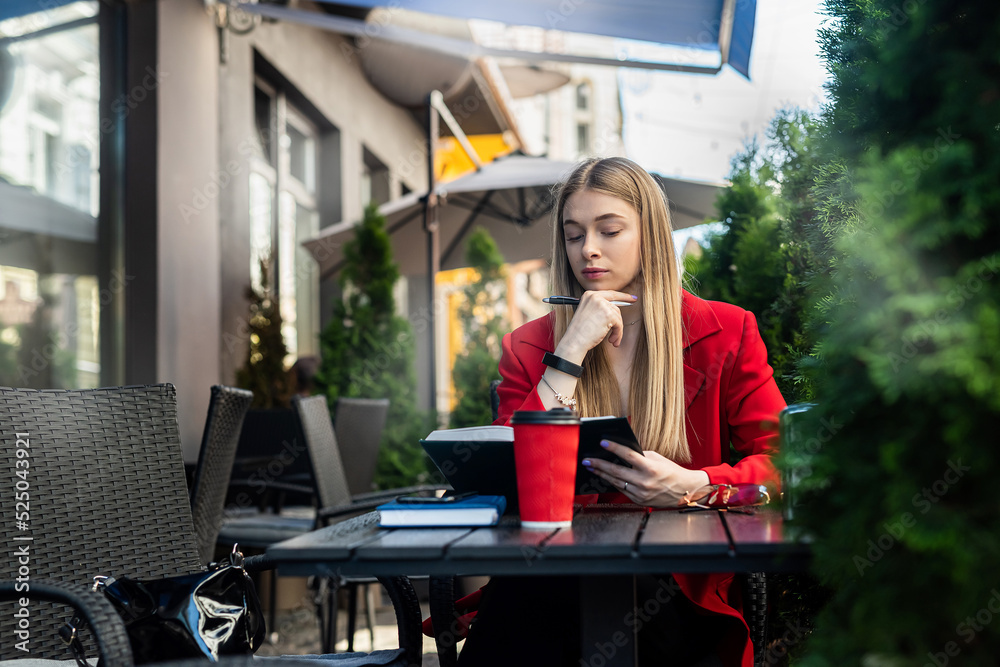 A beautiful blonde with charming hair has breakfast in a cafe using a laptop. A beautiful blonde with charming hair has breakfast in a cafe using a laptop.