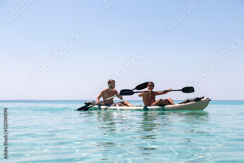 Happy two teenagers kayaking together in amazing clear water of Aegean sea.Happy family adventures concept © Jelena
