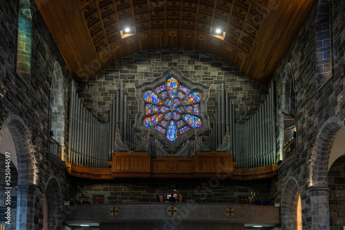 close-up view of the organ and stained glass window in the nave of the Galway Cathedral