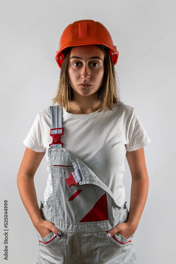 Happy young woman in special overalls for repair isolated on white background. Happy young woman in special overalls for repair isolated on white background.