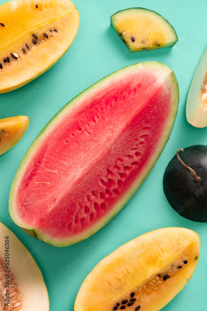 Top view of ripe juicy red and yellow watermelon slices over colorful background. Design for wallpaper, greeting season card. Closeup