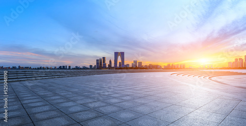Fototapeta Naklejka Na Ścianę i Meble -  Empty floor and modern city skyline with building at sunset in Suzhou, China.