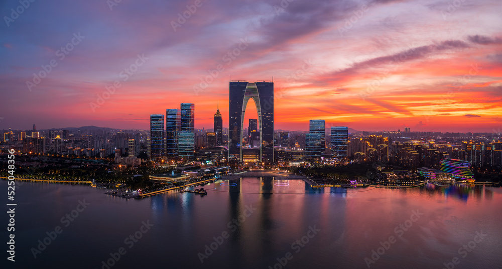 Fototapeta premium Aerial view of city skyline and modern commercial buildings in Suzhou at sunset, China.