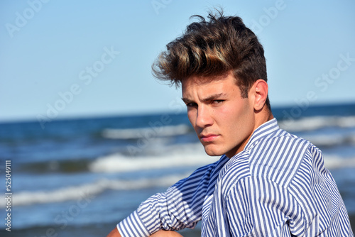 guy posing on the beach alone