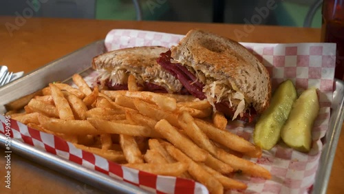 Traditional Reuben sandwichwith pickles and fries, slider 4K photo