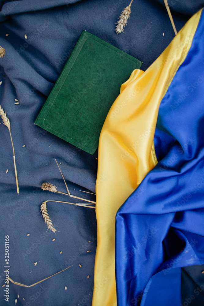 summer thematic composition of the flag of Ukraine, a book and ears of wheat