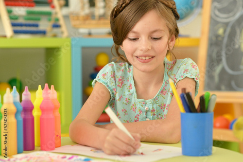 cute girl drawing picture at home