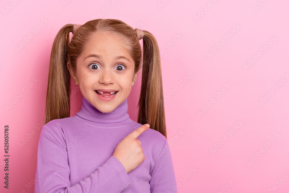 Photo of young little girl with ponytails promote recommend product object isolated on pink color background Photo of young little girl with ponytails promote recommend product object isolated on pink color background