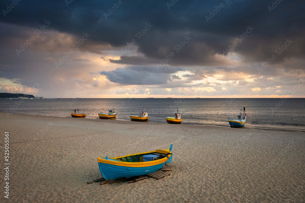 Cloudy sunrise on the beach of Baltic Sea in Sopot with fishing boats, Poland