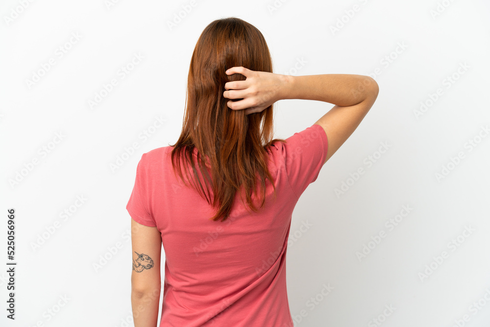 Redhead girl isolated on white background in back position and thinking Redhead girl isolated on white background in back position and thinking