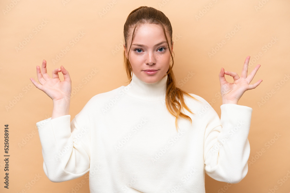 Young caucasian woman isolated on beige background in zen pose Young caucasian woman isolated on beige background in zen pose