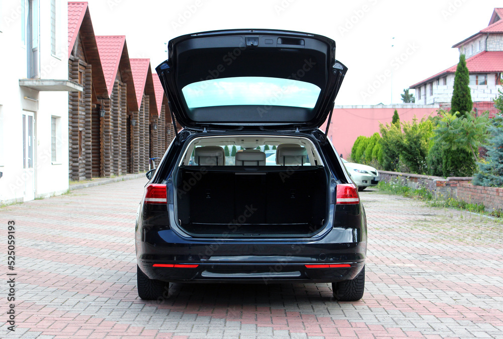 Black modern car with open empty trunk. Modern wagon car open trunk. Car boot is open.