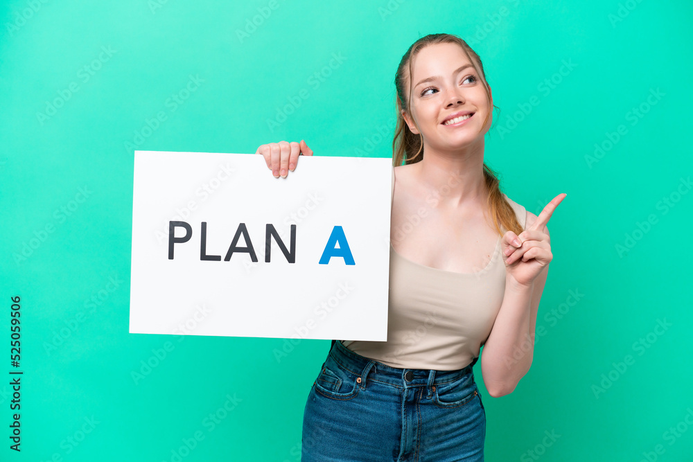 Young caucasian woman isolated on green background holding a placard with the message PLAN A and thinking Young caucasian woman isolated on green background holding a placard with the message PLAN A and thinking