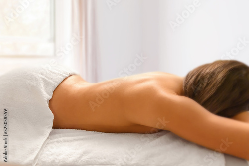 Female enjoying relaxing back massage in cosmetology spa centre