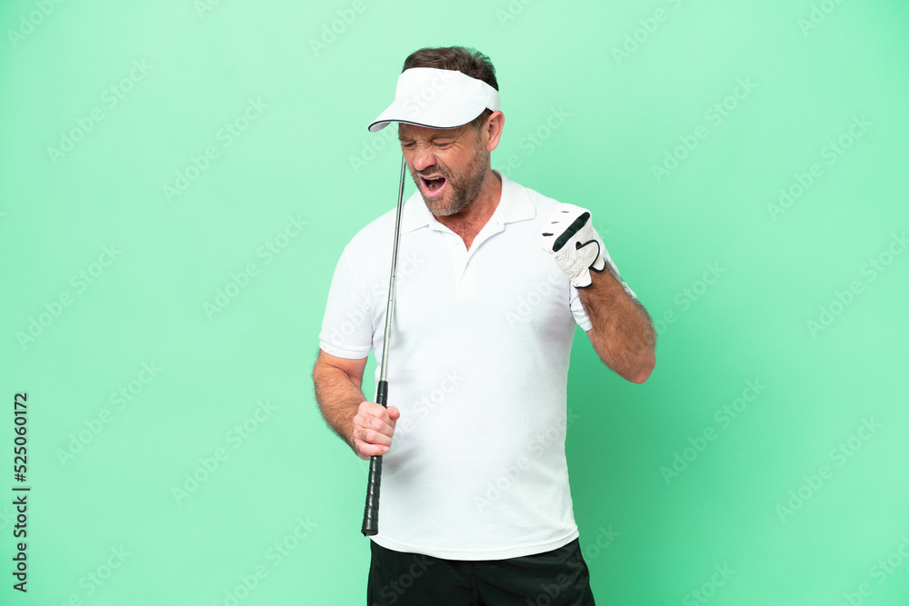 Middle age caucasian man isolated on green background playing golf and celebrating a victory Middle age caucasian man isolated on green background playing golf and celebrating a victory