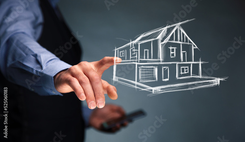man hand phone with house model in screen