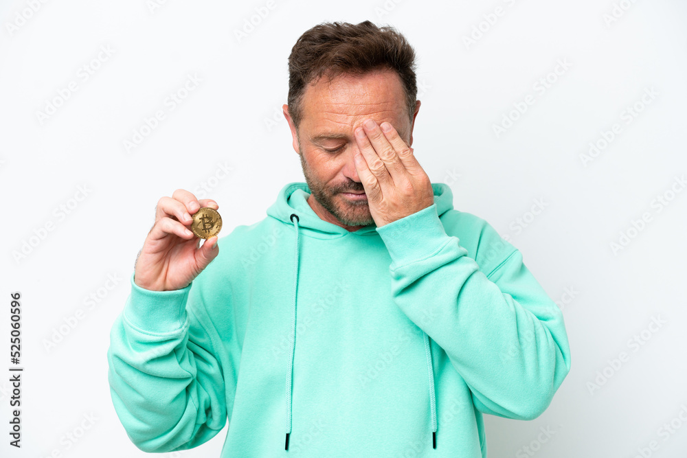 Middle age man holding a Bitcoin over isolated background with tired and sick expression Middle age man holding a Bitcoin over isolated background with tired and sick expression