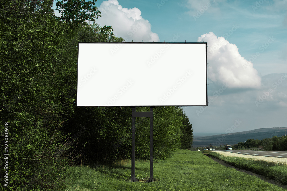 Empty billboard for advertising poster near asphalting road and green forest, on background of blue sky. Empty billboard for advertising poster near asphalting road and green forest, on background of blue sky.