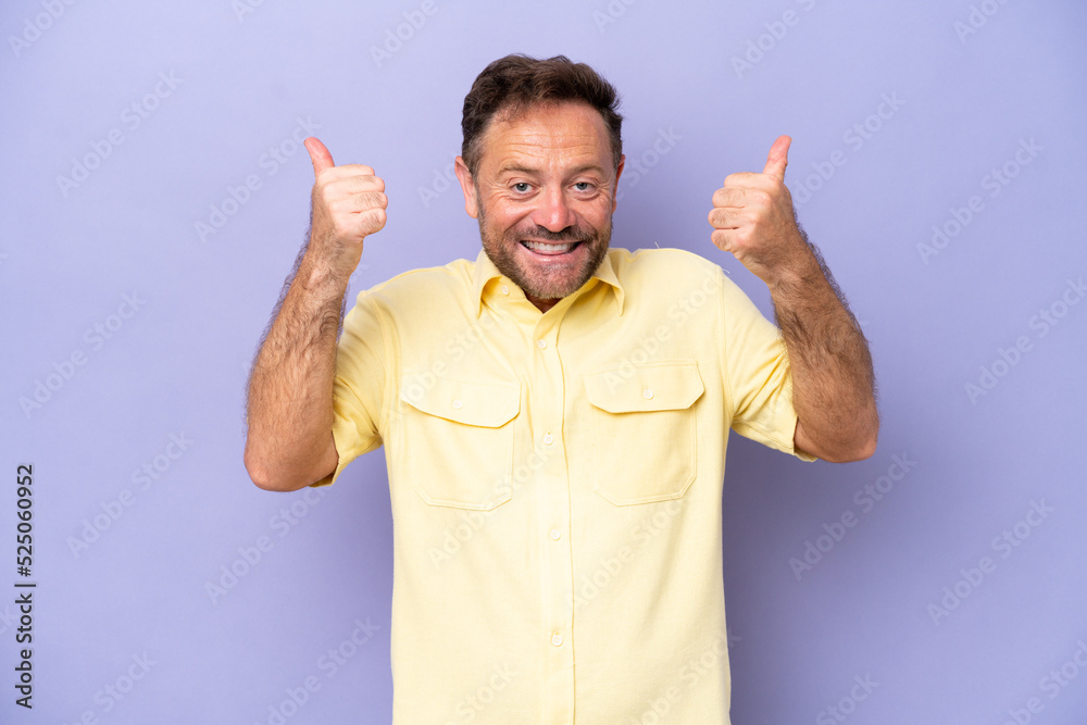 Middle age caucasian man isolated on purple background giving a thumbs up gesture Middle age caucasian man isolated on purple background giving a thumbs up gesture