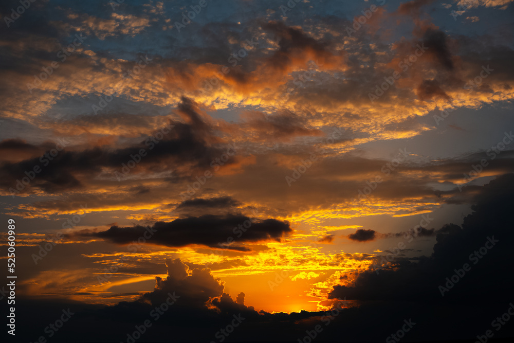 Beautiful landscape of sunset with dark colourful clouds. Natural background.