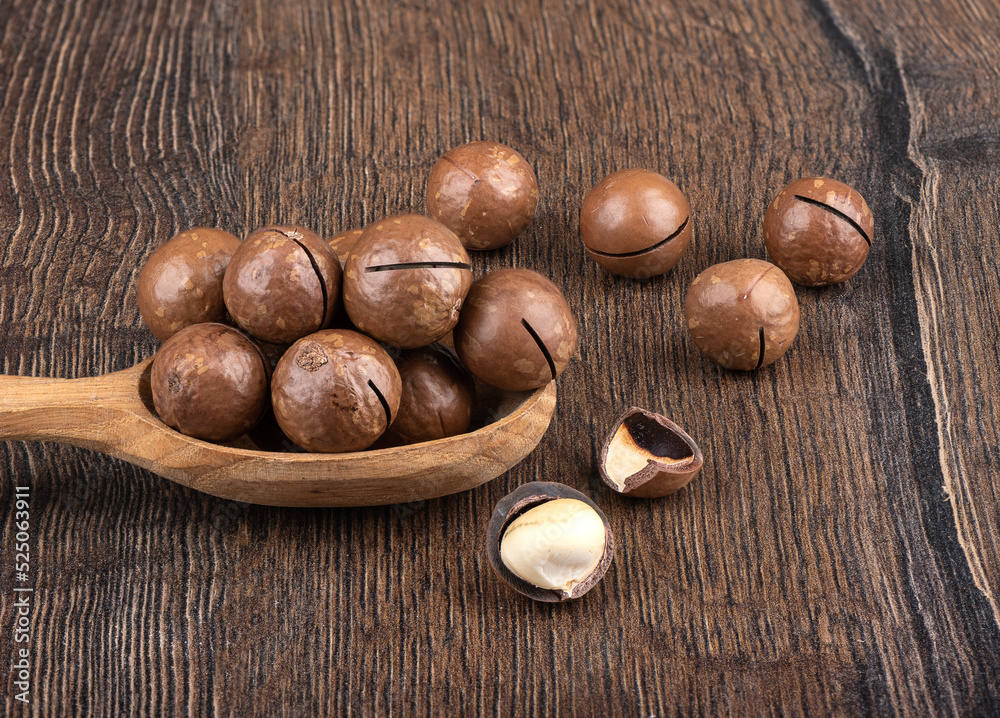 Macadamia nuts and nut shells on a wooden background. Macadamia nuts and nut shells on a wooden background.