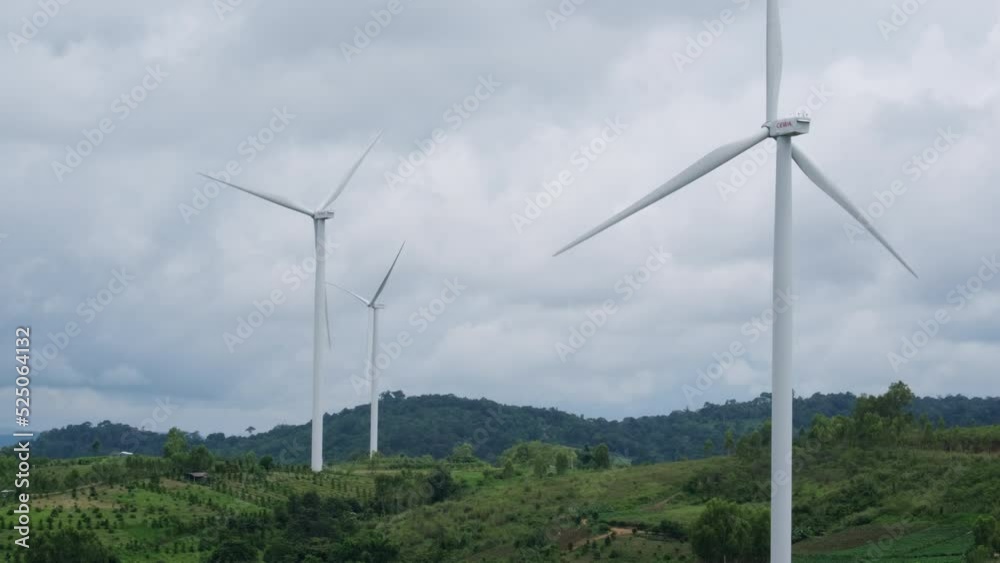 Panoramic view of wind turbines or wind farm with beautiful landscapes and blue sky to generate clean renewable green energy for sustainable development. Windmills for electric power production. Panoramic view of wind turbines or wind farm with beautiful landscapes and blue sky to generate clean renewable green energy for sustainable development. Windmills for electric power production.