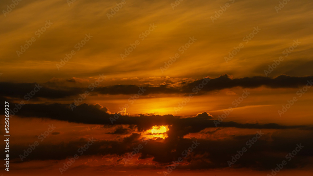 Dark cloudy clouds and golden yellow color of skyline during the sunrise, Amazing orange sky in the morning while the sun is going up, Horizon nature background.