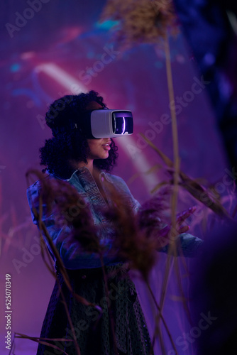 Metaverse digital cyber world technology, woman with virtual reality VR goggles playing augmented reality game, futuristic lifestyle