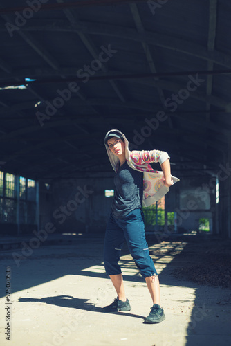 Young female hip hop dancer dancing and jumping in abandoned building on a sunny summer day   © Solid photos