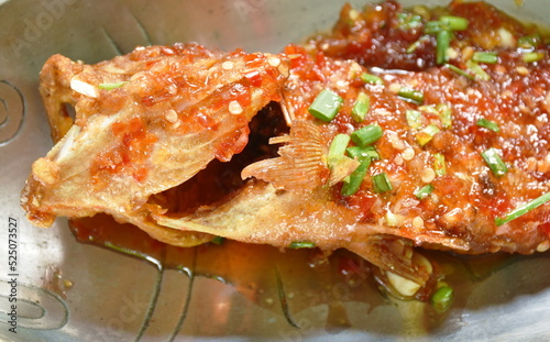 deep fried red banded grouper fish dressing sweet chili sauce on plate  photo