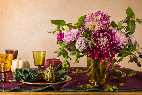 Festive table setting for Thanksgiving day. Autumnal decorations,plates, mult...