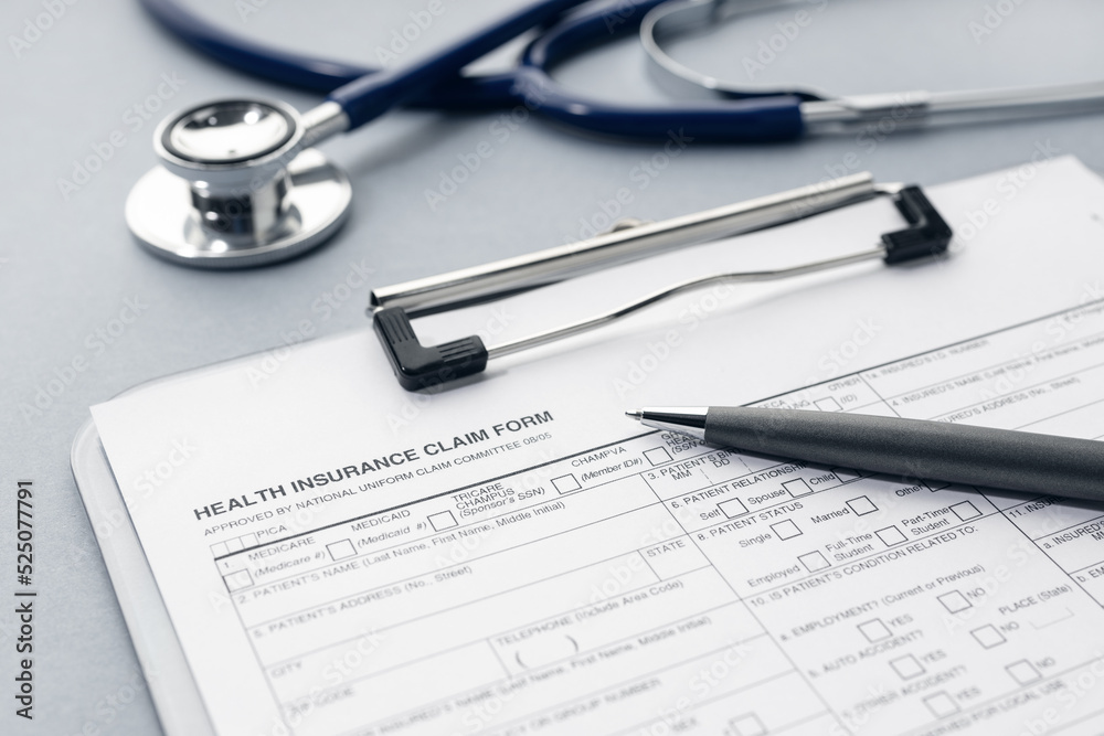 Health Insurance claim form and stethoscope on desk Health Insurance claim form and stethoscope on desk